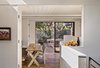 Guests now dine on a table from Coup d’Etat in the space where the residents used to enter the house. The dining room feels much larger than it actually is, thanks to a ten-foot-wide sliding glass door that opens onto a second, outdoor lounge. Photo 7 of Torres House modern home