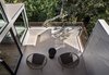 Modern home with Outdoor, Small Patio, Porch, Deck, Rooftop, and Concrete Patio, Porch, Deck. “When you have a tiny house, having outdoor spaces off a room can make a big difference,” Schicketanz says. Luckily, each room already had its own deck, which the architect simply refurbished by installing concrete floors and galvanized stainless steel railings. Photo 10 of Torres House