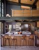 Modern home with Kitchen, Track Lighting, Ceiling Lighting, Recessed Lighting, Concrete Floor, Wood Cabinet, Undermount Sink, and Pendant Lighting. Norman Cherner barstools from Design Within Reach line the island in the kitchen, which is crowned by an open loft office. The faucets are from Dornbracht; the countertops are Caesarstone. Hawkins integrated a steel-clad casual eating nook, at left. Photo of One Architect, Five Ways to Do a Modern Kitchen