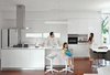 Modern home with Kitchen, White Cabinet, Wall Oven, Pendant Lighting, Range Hood, Medium Hardwood Floor, Recessed Lighting, Undermount Sink, and Cooktops. For the kitchen, architect Ivan Priatman selected an oven, hood, and cooktop from Teka and a Samsung refrigerator. While the table is his own design, the bar stools and chairs are from Informa.
Photo of A Tropical Indonesian House that Spirals Out from a Central Courtyard