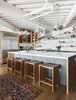 White also dominates the kicthen, also by Henrybuilt, with accents of stainless steel and wood. Photo 5 of Parker Willis House modern home