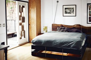 Mad Men star Vincent Kartheiser decided to go small, buying and moving into a 580-square-foot cabin. Here, a curtain slides across for privacy, but the home’s masterstroke is a bed that descends from the ceiling. The pulley system that controls the hanging bed needed some serious hardware, including a 300-pound steel counterweight that’s hidden in a corner of Kartheiser’s closet.