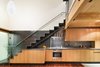 A loft staircase hovers above the kitchen at architect Jack Hawkins' personal residence, maximizing every inch of its 1,000-square-foot footprint. Photo of One Architect, Five Ways to Do a Modern Kitchen modern home