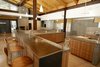 A lengthy steel bar, a recurring motif in Hawkins' work that can be seen in his Reno kitchen remodel, is the centerpiece of the communal area in this Washoe Valley, Nevada, home. Photo of One Architect, Five Ways to Do a Modern Kitchen modern home