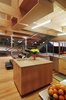 The island at this Virginia City, Nevada, home comes in the form of a compact cube, flanked by a dramatic metal staircase. Photo of One Architect, Five Ways to Do a Modern Kitchen modern home