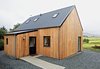 “It’s a beautiful part of the world,” says architect Alan Dickson about Scotland's Isle of Skye. “The downside of that beauty is that land is expensive and very difficult for young people to afford, so they’re leaving the island.” In 2010, Dickson, of the Skye-based firm Rural Design, and local builder James MacQueen came up with a solution: a small timber-frame prefab design called the R.House, which can be constructed quickly and tucked onto less expensive lots that don’t appeal to well-heeled holiday homeowners.
Photo by Marcus McAdam. Photo of Sourcing Guide for Modern Prefab Companies in Europe modern home