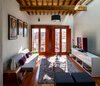 The family room, on the second story of the old building, is a place for gathering and relaxing. Behind the balcony doors, the room is accented by Modernica Case Study V-Leg daybed and BluDot ottomans and coffee table. Photo 7 of Hybrid Home modern home