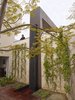 The two story outdoor shower and spa features a water wall formed of bent steel. If the homewowner prefers an extended dip, the lid of the hot tub can slide right up to the edge of the shower. Photo of A Spa-Like Patio with Stunning Views Cascades Down a Los Angeles Hillside modern home