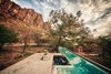 A solar-heated lap pool sits at the home’s perimeter. It makes a visual impact with white tiles in the lap lane, contrasted with black tiles in the jacuzzi. Photo of This Super Green Home in Mexico Embraces Nature Through Huge Pivoting Glass Doors modern home