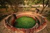 Every drop of water that is not captured in the potable water tank is funneled through stone canals to an open reservoir. The water here is in constant motion. An electrical pump, along with plants and fish, maintain the delicate ecosystem. This water is used for toilets, gardening, cleaning, and maintenance. Photo of This Super Green Home in Mexico Embraces Nature Through Huge Pivoting Glass Doors modern home