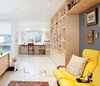 Custom birch millwork, fabricated by Toronto's Gibson Greenwood, defines a home office space on the second floor. Susan brought the yellow couch at right when she emigrated from Hungary in 1969. Photo of 40+ Yellow Modern Home Design Ideas modern home