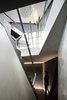 The challenge of building as angular a house on a 12 ft grade was visualizing how various vertical and horizontal planes would meet. The staircase serves as the backbone of the plan. Photo 2 of SRK modern home