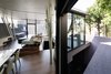 The retaining walls not only block views of the neighbors, but also reflect light back into the space. Tilting the walls outward enhances the overall openness of the space. Photo 4 of SRK modern home