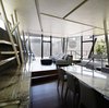 The architects explain that sleek European furniture adds strength to an otherwise flat, airy room with several sheer walls. Vol au Vent by Mario Bellini dining chairs complement the granite dining room surfaces. The sofa is Hamilton Islands by Minotti. Photo 5 of SRK modern home