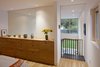 The home’s open floor plan is exemplified by the loft-like master suite that looks out onto the backyard through a double-height living room. Sliding pocket doors and windows (invisible here), allow for privacy and separation when desired. Photo of A Green Portland Home Built to Passive House Standards modern home
