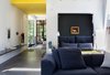 When folded down, deep navy-blue cushions give the effect of a lush headboard. While the home does not yet have a proper master bedroom, the couple plans to create an addition sometime next year. Photo of Blue Mood: 9 Creative Ways to Use Color modern home