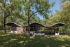 Modern home with Exterior, Stone Siding Material, House, and Glass Siding Material. The Gregory Residence is a masterclass example in design. Furnished by renowned New Hope woodworker George Nakashima, this private and rustic home offers ingenious versatility over its 1,644 square feet of space on a 10-acre lot. Photo of Unforgettable Midcentury Homes by Modern Masters