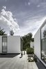 Modern home with Outdoor, Trees, Concrete Patio, Porch, Deck, and Large Patio, Porch, Deck. The project title “Casa 4.1.4” refers to the four main volumes, one central plaza and four patios. This simple configuration creates distinct, private spaces tied together with open-air common areas. Photo of A Minimalist Mexican Retreat that Uses an Array of Strategies to Beat the Heat