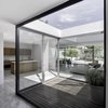 This enclosed patio within one of the modules invites residents to enjoy the outdoors while still protected from the intense heat. The dining room table and chairs designed by Hector Esrawe. Photo of A Minimalist Mexican Retreat that Uses an Array of Strategies to Beat the Heat modern home
