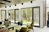 Modern home with Living Room, Sofa, Concrete Floor, Rug Floor, Ceiling Lighting, Coffee Tables, Lamps, and Chair. Low-impact materials were also used for the interior design, which is comprised primarily of concrete, glass, stone, wood, and steel. A palette of mostly light and neutral shades puts the attention on the views. Photo 4 of Chalet Lac Gate