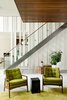 Modern home with Living Room, Concrete Floor, Rug Floor, Chair, and Stools. Raw wood planks were painted white and fitted next to a staircase and banister by Bättig Design. Matching chairs by Thayer Coggin sit atop a Crate and Barrel rug. Photo 6 of Chalet Lac Gate
