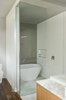 Modern home with Bath Room, Freestanding Tub, and Corner Shower. An Emily quartz bathtub by Caml-Tomlin is surrounded by Ceragres’ fade and frammenti tile. Photo 8 of Chalet Lac Gate