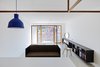 Modern home with Storage Room and Shelves Storage Type. A large bed hides behind the couch. The lights affixed to the canopy bed frame are Nordlux Cyclone reading lamps. Photo 4 of Strikingly Minimal