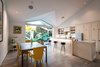 The architects explain, “This house has tile plank flooring throughout with no transition steps at showers and doors. And because indoor/outdoor living is an integral part of San Diego living, large glass sliding doors completely open the house to the private patio that was hidden in the prior plan layout.” Photo of A California Cottage Renovated for Easy Indoor-Outdoor Living modern home