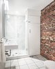 Modern home with Bath Room, Enclosed Shower, Porcelain Tile Floor, and Wall Mount Sink. Along with historic wood and steel details, several warm brick walls were exhumed and left exposed. Photo 4 of Beacon Hill