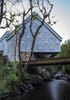 Modern home with Exterior, Metal Roof Material, Metal Siding Material, House, and Cabin Building Type. Occupying a footprint of just 110 square feet, the studio finds smart ways to maximize space. Central to this undertaking is the studio’s cantilever, which appears to float over the stream. The cantilever affords the studio more internal volume, while occupying no greater footprint below. Photo 2 of Midden Studio