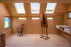 Modern home with Office, Craft Room, and Chair. Light is controlled in the studio to facilitate the artist’s work. Half of the studio is flooded with northern light for traditional art forms such as sculpture and drawing, while the other half minimizes light to avoid screen glare for digital work. Photo 4 of Midden Studio