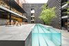 Modern home with Outdoor, Walkways, Trees, Large Patio, Porch, Deck, Concrete Patio, Porch, Deck, Hardscapes, and Lap Pools, Tubs, Shower. A pool is still the focal point of the courtyard, but its modernized, streamlined design makes a dramatic statement. Photo 3 of Hotel Carlota