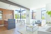 Pre-finished Varmland oak by Berg & Berg cover the front unit’s living room, dining room, and kitchen floors. A CB2 Capitol Pendant Light hangs above the dining table. Photo of A San Francisco Renovation Creates Two Apartments from One modern home