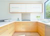 Dawson Wood Interiors of Truckee, California built the rear unit’s kitchen cabinets with rift white oak. Cornerstone quartz countertops and Ikea parts complete the space. Photo of A San Francisco Renovation Creates Two Apartments from One modern home