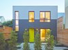 The rear unit’s front entrance faces the courtyard, and has the same acrylic stucco and painted wood siding as the front unit’s exterior. The door, which has a custom-steel awning over its frame, is painted in “hep green” by Sherwin-Williams. Photo of A San Francisco Renovation Creates Two Apartments from One modern home