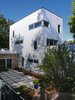 Modern home with Outdoor, Front Yard, Small Patio, Porch, Deck, Shrubs, Pavers Patio, Porch, Deck, and Trees. The gated courtyard was conceived in halves: a slightly sunken sandbox-like patio and a miniature green space. Its connection to both pieces of the house and the garage encourages traversal and use as an outdoor living space. Photo 3 of Ravenswood Residence