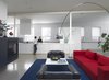 Saturation demarcates the line between the primary living space and kitchen in the existing open-plan structure. Were it not for tonal contrasts, aided also by a ground and polished concrete floor, the kitchen would be a virtual whiteout. Photo 5 of Ravenswood Residence modern home
