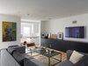 Modern home with Living Room, Recessed Lighting, Sectional, Chair, Coffee Tables, and Light Hardwood Floor. In the newly built media room, lower ceilings and natural wood flooring make for a straightforward character shift. “We always liked John’s minimalism,” adds Dave, and even such slight differentiation ably signals the transition to the home’s more private spaces. Photo 6 of Ravenswood Residence