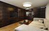 Modern home with Shed & Studio, Den Room Type, and Home Theater Room Type. Downstairs in the basement, an entertainment room is inspired by the idea of an English pub. Dark, rich wood tones are favored in this popular meeting place for friends. The space was designed to be soundproof in order to maintain privacy from the two older children's bedrooms, also on the basement level. A wine bar, flat screen TV, and stainless steel table complete the space. Photo 7 of Rishon Le Zion 3