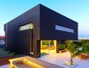 The voluminous black plaster cube appears to float over the open first-floor at the rear elevation. On the roof, solar panels generate about 80 percent of the home’s electrical and heating needs. The landscaped backyard was designed to resemble an orchard, and includes several defined areas for socializing and entertaining. Photo 8 of Rishon Le Zion 3 modern home