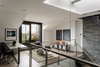 Ruhl Walker Architects designed the custom desk in Tabu Caleidolegno veneer and black oxide steel, which was then constructed by Herrick & White. The study also features Eames Molded Plastic Rockers from DWR. Photo 6 of Back Bay modern home
