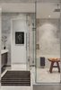 The master bathroom’s marble tile wall is by White Venatino marble, with gray accent tile from Florim USA. A Wetstyle bathtub stands in the corner. Photo 7 of Back Bay modern home