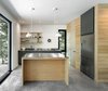 The Spahaus model is modular and available in five configurations. They vary in size from 1070 square feet to 1420 square feet. In the kitchen, gray laminate cabinets are topped with stainless steel countertops. Photo 3 of Spahaus modern home