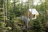 Modern home with Exterior, Metal Roof Material, Wood Siding Material, House, Cabin Building Type, and Gable RoofLine. The facade consists of exposed concrete, Galvalume roofing, and cedar or torrefied wood coating. The homes are carefully positioned to keep other structures out of sight. Photo 5 of Spahaus
