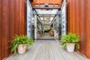 “We wanted it to feel open and spacious,” Alexander said. Much of the work on the containers was completed off-site by SG Blocks, and then delivered for construction. It's clad in Cor-Ten weathering seel. Photo of A Restaurant Constructed from 19 Salvaged Shipping Containers modern home