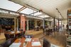 Other than some use of drywall, the structure is completely made of shipping containers. Photo of A Restaurant Constructed from 19 Salvaged Shipping Containers modern home