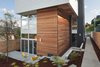 “The local cedar and Douglas fir used inside and outside creates a simple, elegant, and timeless feeling for the home,” said Weber. The wood exterior was installed below exterior lap siding painted Benjamin Moore’s “Glacier White.” Photo of Cedar Douglas Residence modern home