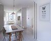 Many of the home’s Victorian features were carefully preserved, including the original stairs and banister. The original floorboards were sanded, painted, and patched with pine filler boards where necessary. Photo of A Compact, Light-Filled Victorian Renovation in England modern home