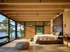 Modern home with Bedroom, Bed, and Wall Lighting. On San Juan island, Pole Pass is an intimate waterfront retreat built to serve as a gathering space that takes advantage of the temperate Pacific Northwest summers. Photo of Olson Kundig Houses