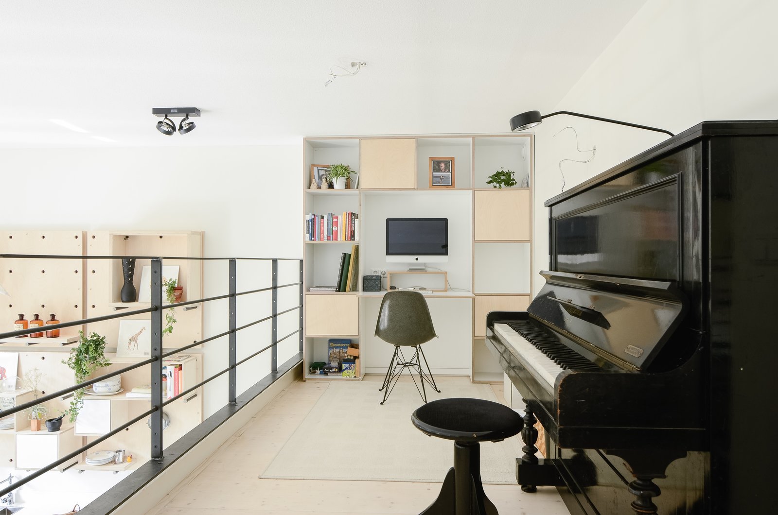 The loft addition afforded space for a home office and music area. The family chose to forego a dedicated office upstairs, instead prioritizing private bedrooms for each of the children. Shelving and a built-in desk anchor the loft’s far wall.